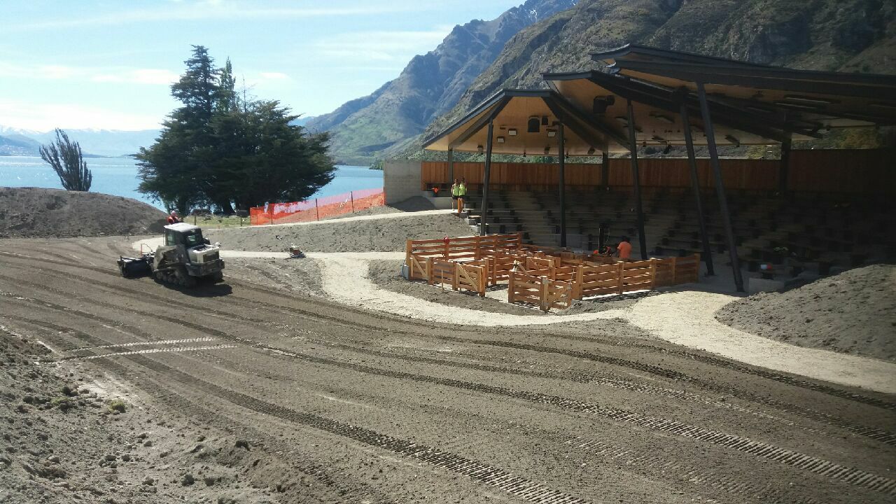 Small loader working on a large gravelled area next to a seating pavillion at Walter Peak Station, Lake Wakatipu.